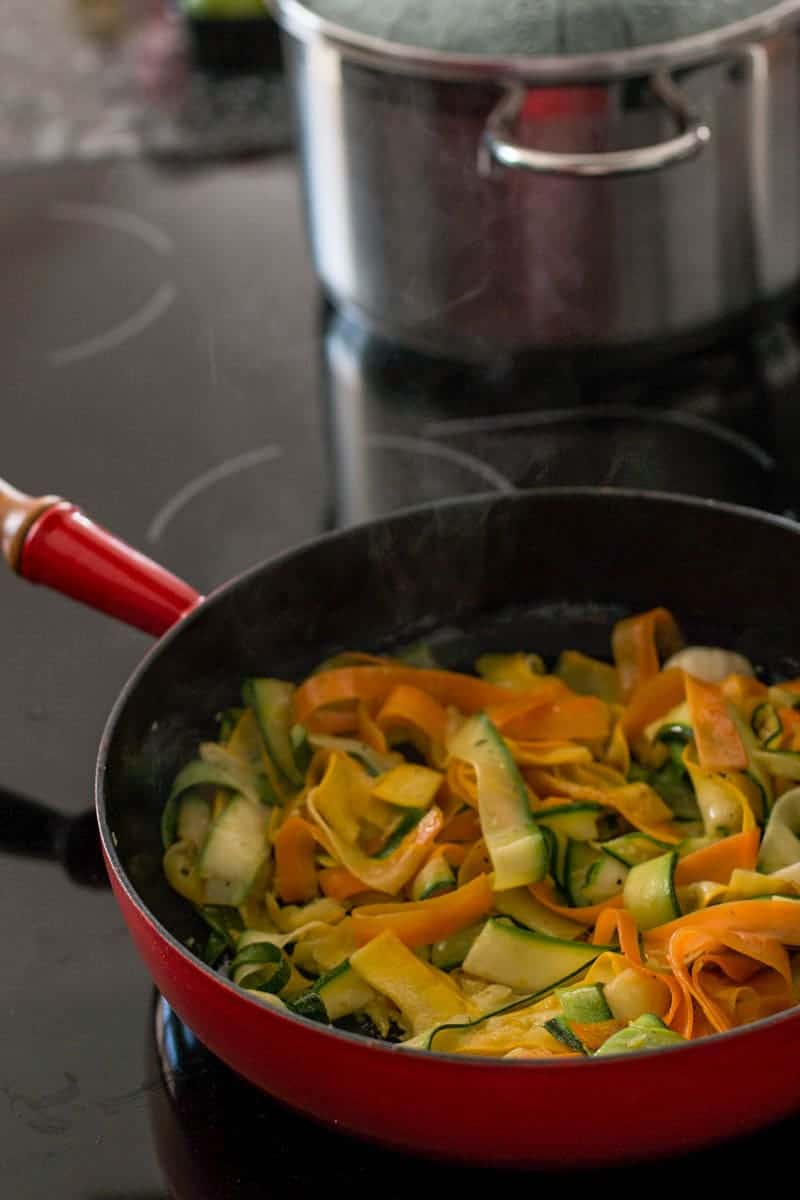 skillet with zucchini and carrots on the stove