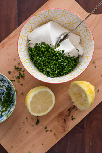 top down view on bowl with ricotta, lemon and herbs