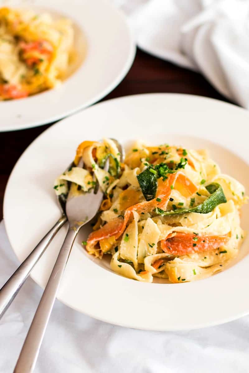 two white plates filled with summer squash and ricotta pasta