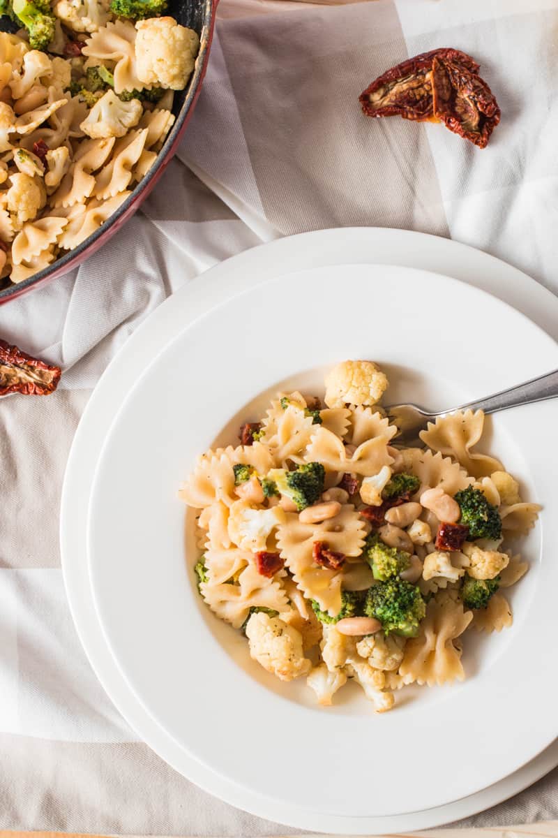 top down view on white plate with pasta and vegetables