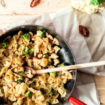 top down view on skillet with pasta, broccoli and cauliflower