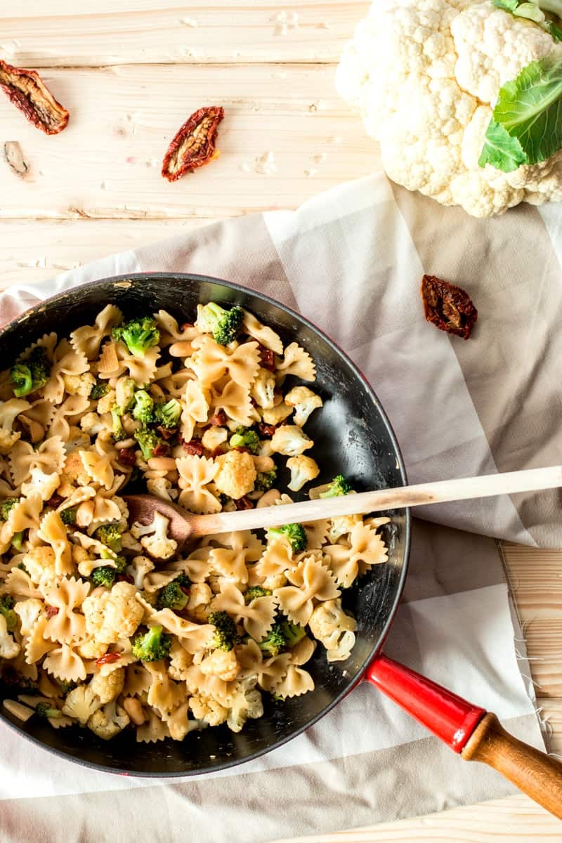 top down view on skillet with pasta, broccoli and cauliflower