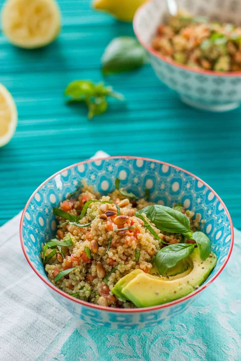 bowl of quinoa salad on a blue tablecloth