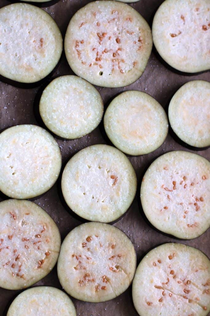 sliced eggplant on a parchment paper