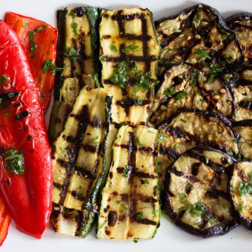 top down view on grilled vegetables on a white platter