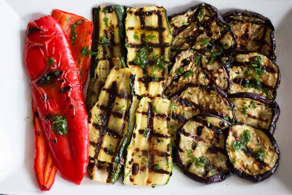 top down view on grilled vegetables on a white platter