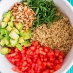 close up view of unmixed quinoa salad in a bowl