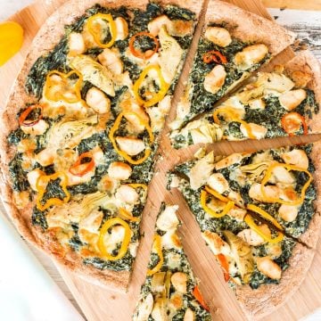 top down view on sliced spinach artichoke chicken pizza