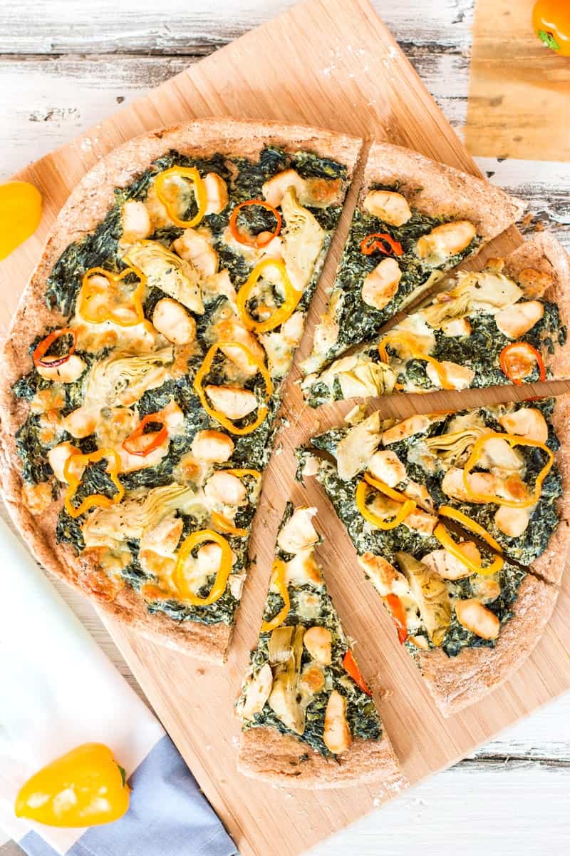 top down view on sliced spinach artichoke chicken pizza