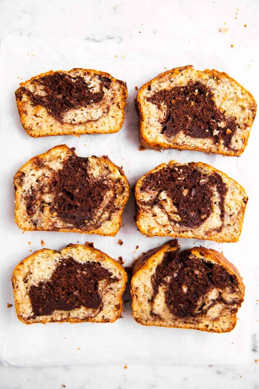 six sliced of chocolate marble banana bread on marble surface