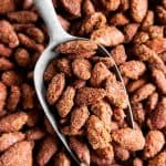 overhead view of small metal shovel in pan with candied almonds