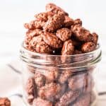 frontal view of jar overflowing with glazed almonds