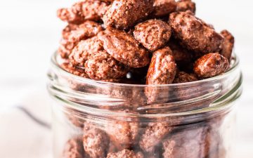 frontal view of jar overflowing with glazed almonds