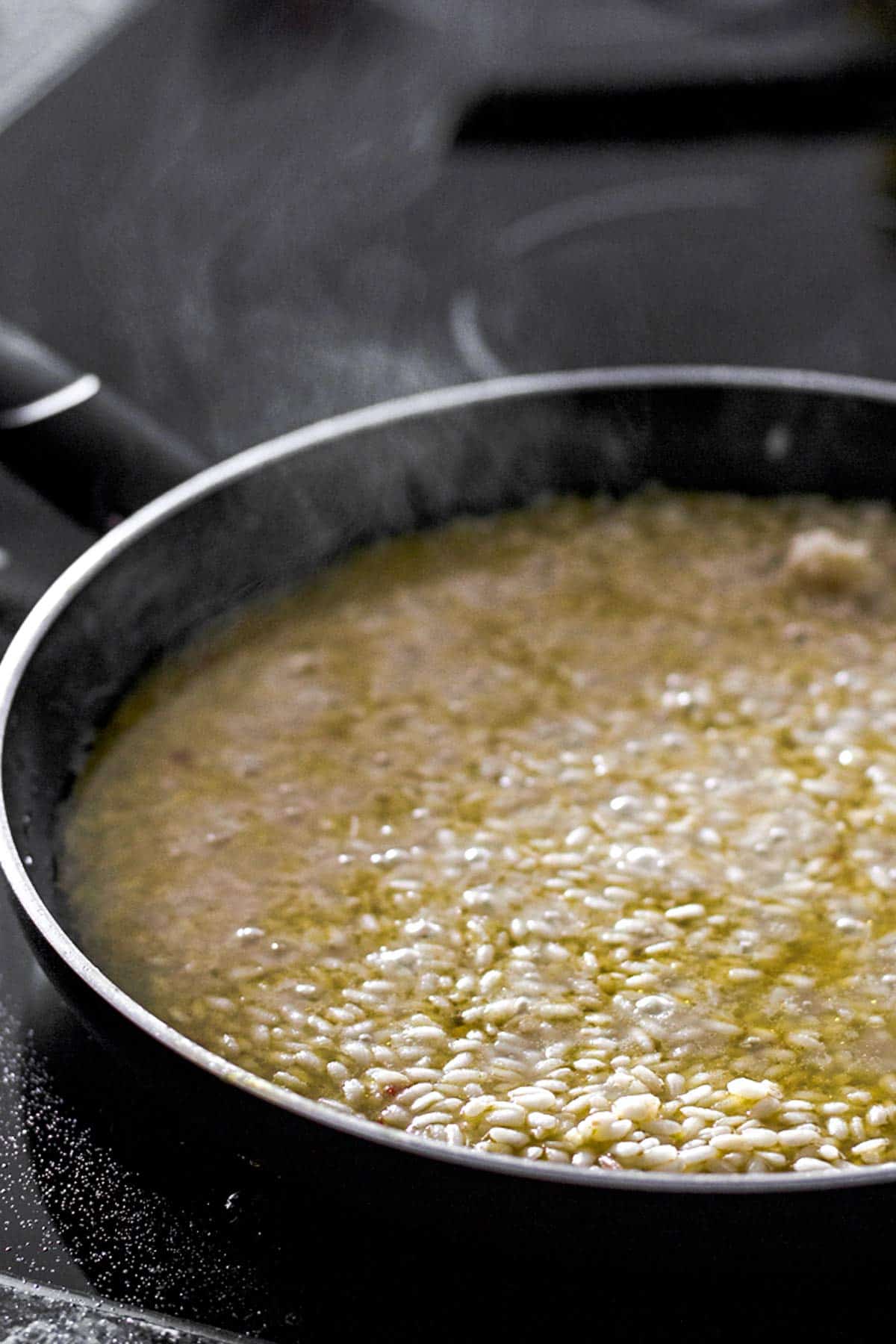 frontal view on skillet with risotto simmering inside