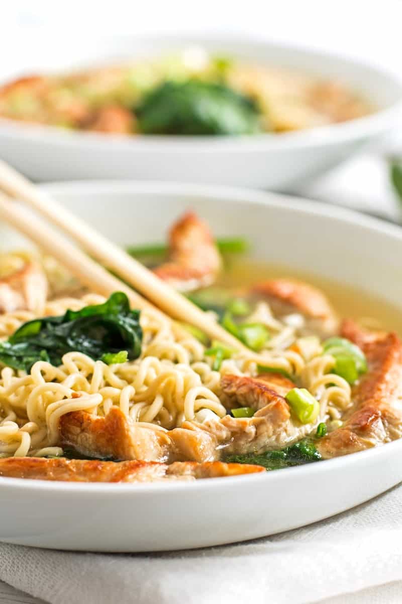 frontal view on two white plates with turkey ramen soup