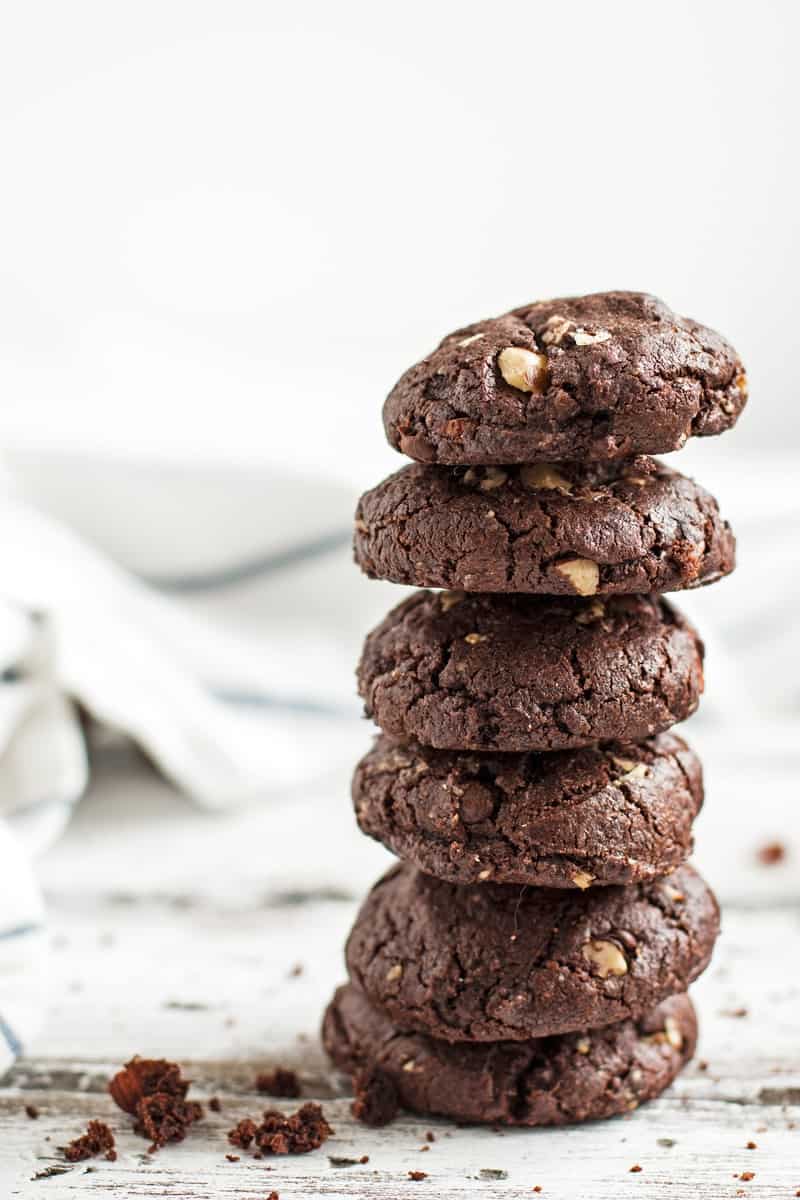 Stack of chocolate cookies on a white surface.