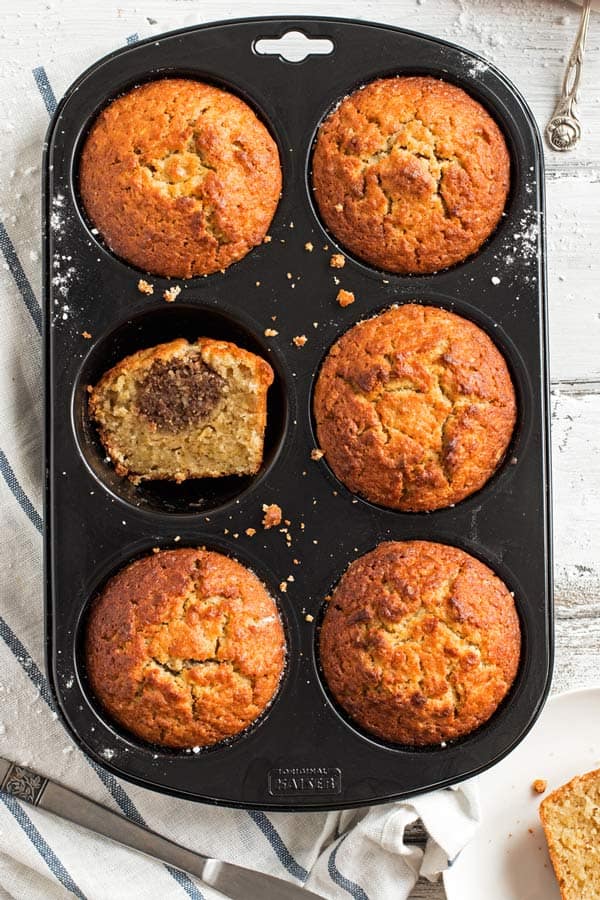 muffin pan with stuffed apple muffns