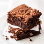 stack of 2 brownies on a white plate