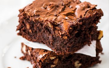 stack of 2 brownies on a white plate