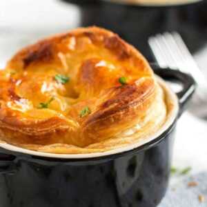 frontal view on chicken and mushroom pot pie in black ramekin