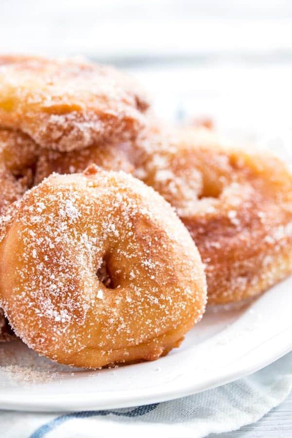 a pile of apple fritters on a white plate