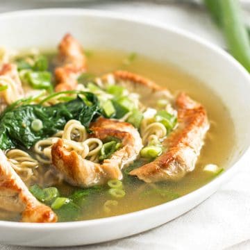 frontal view of white bowl filled with turkey ramen soup