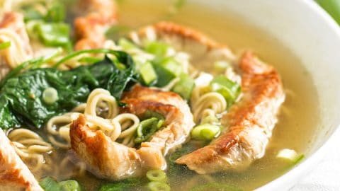 frontal view of white bowl filled with turkey ramen soup