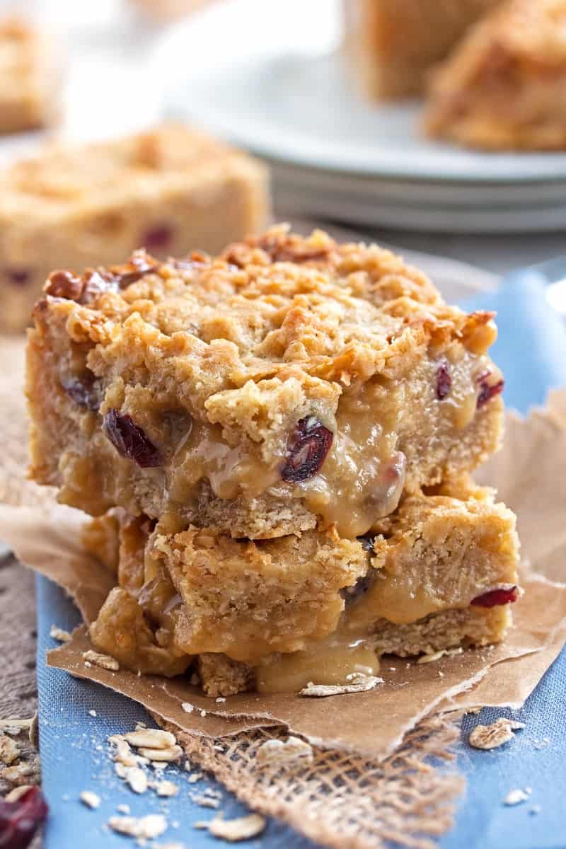 stack of Cranberry White Chocolate Oatmeal Bars on a blue napkin