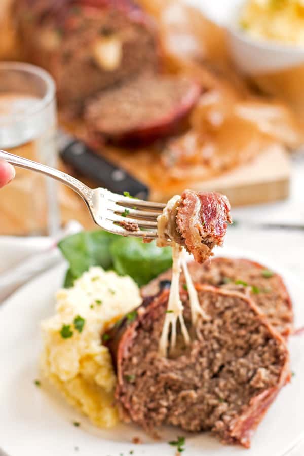 eating cheese stuffed meatloaf with a fork