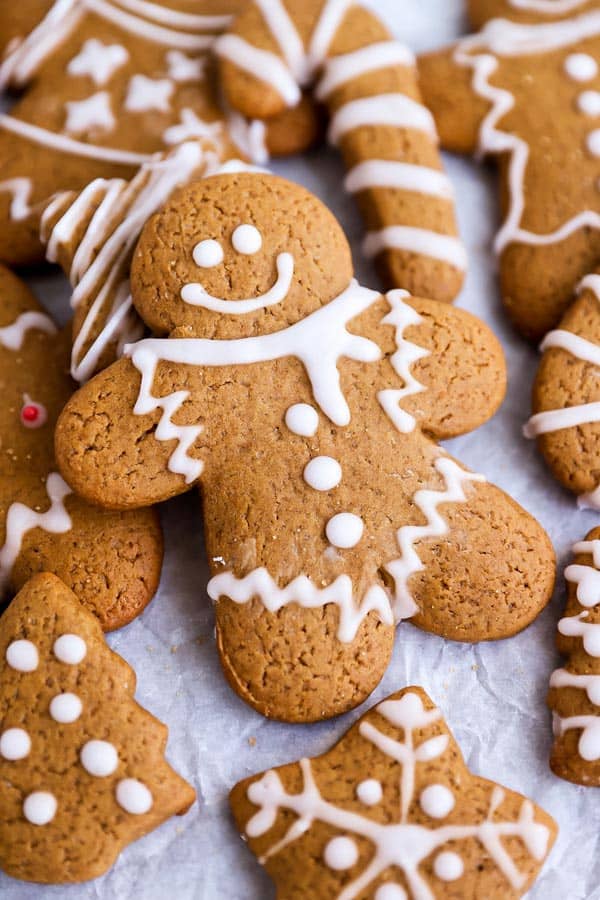 a gingerbread man lying on top of other gingerbread cookie shapes