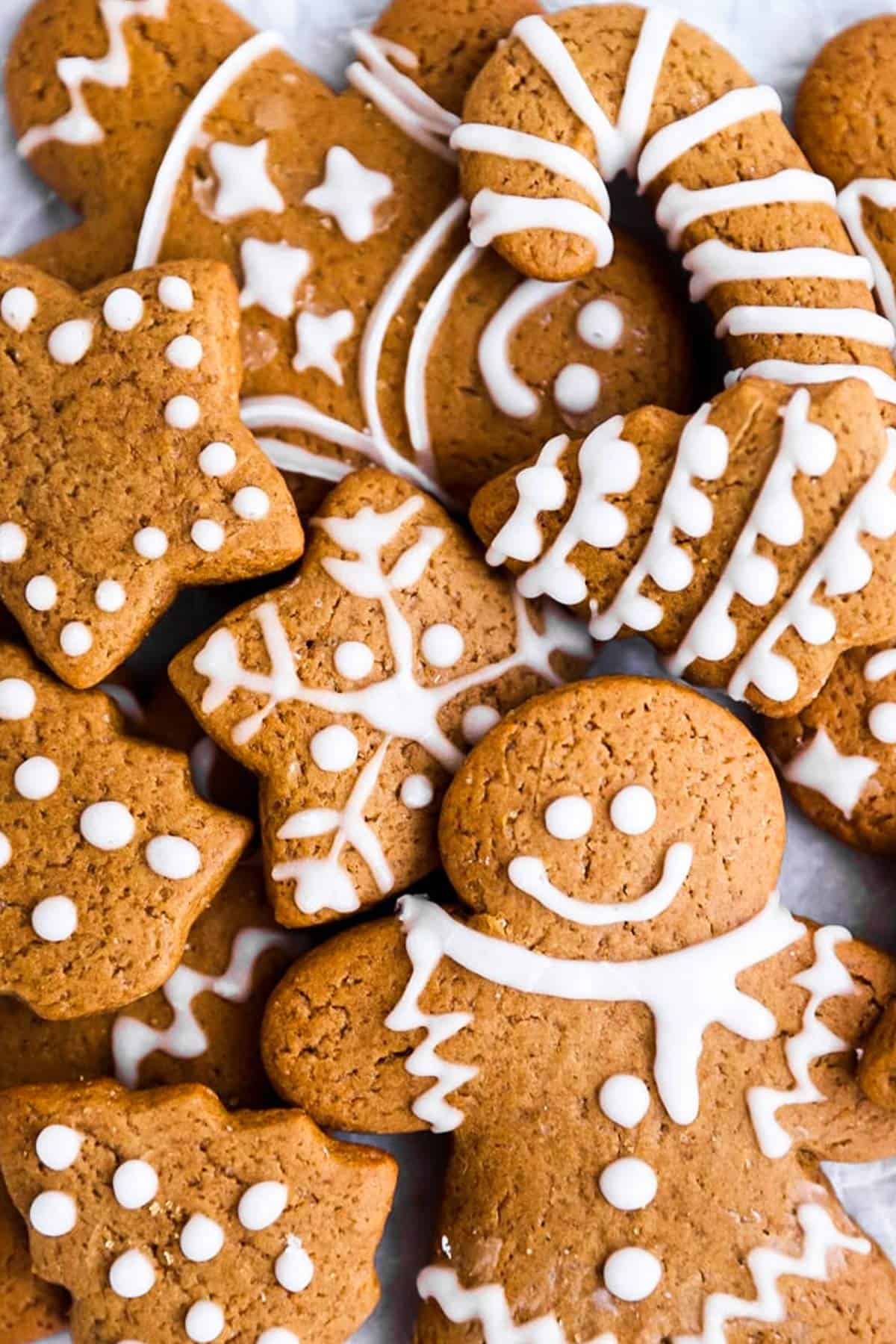 pile of cut out gingerbread cookies with icing