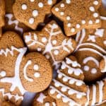 pile of gingerbread men and gingerbread cookie shapes decorated with icing