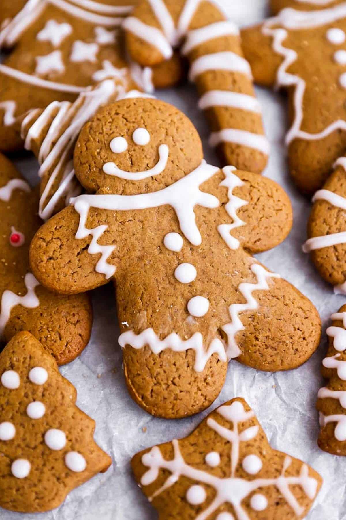 a gingerbread man lying on top of other gingerbread cookie shapes