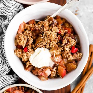 top down view on bowl with fruit crisp and ice cream