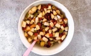 top down view on white bowl with fruit crisp filling