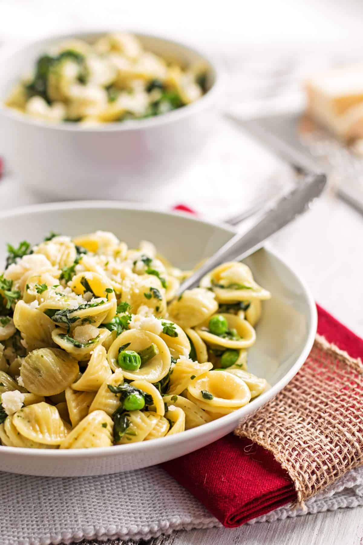 frontal view on white plate with spinach pea pasta