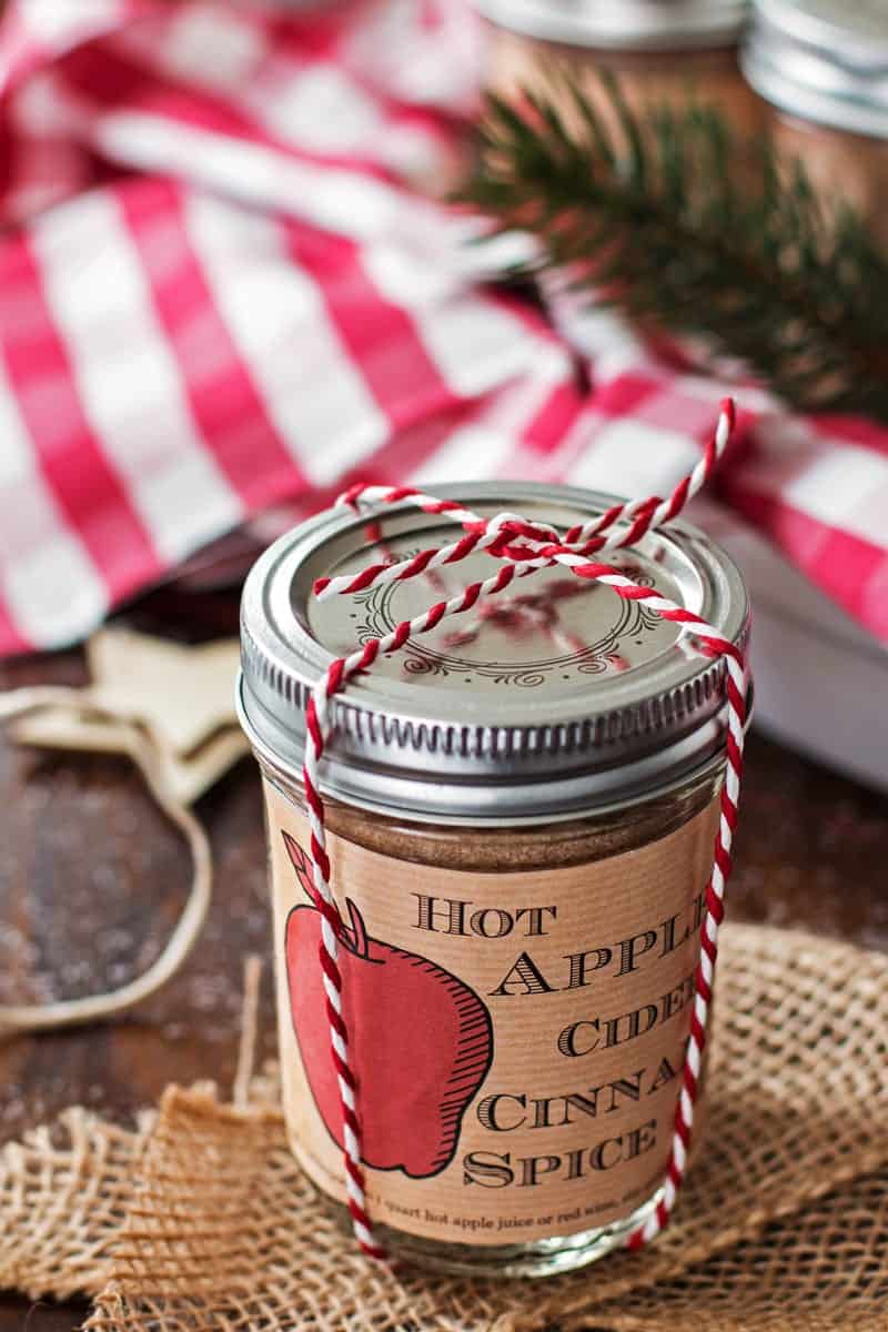 jar of apple cider spice mix tied with baker's twine on a festive tables cape