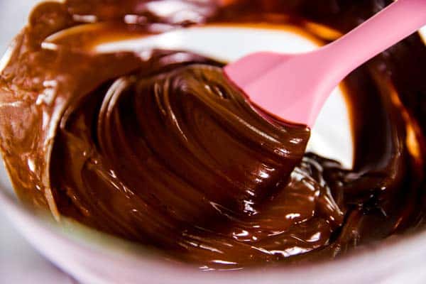 melted chocolate being stirred with a pink rubber spatula