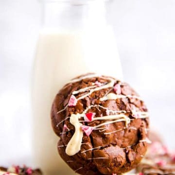 peppermint brownie cookie leaning against a bottle of milk