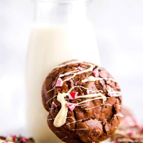 peppermint brownie cookie leaning against a bottle of milk