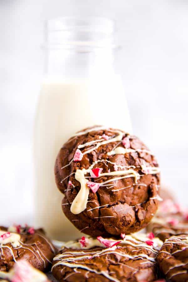 peppermint brownie cookie leaning against a bottle of milk
