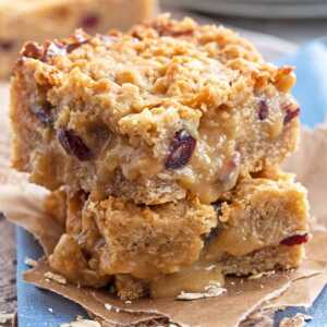 close up view of two stacked gooey oatmeal bars