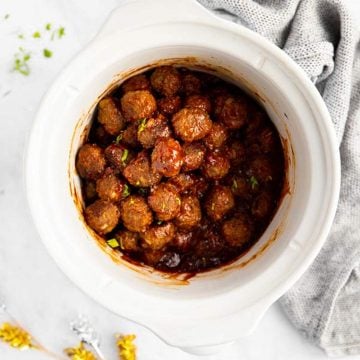 white slow cooker with bbq meatballs