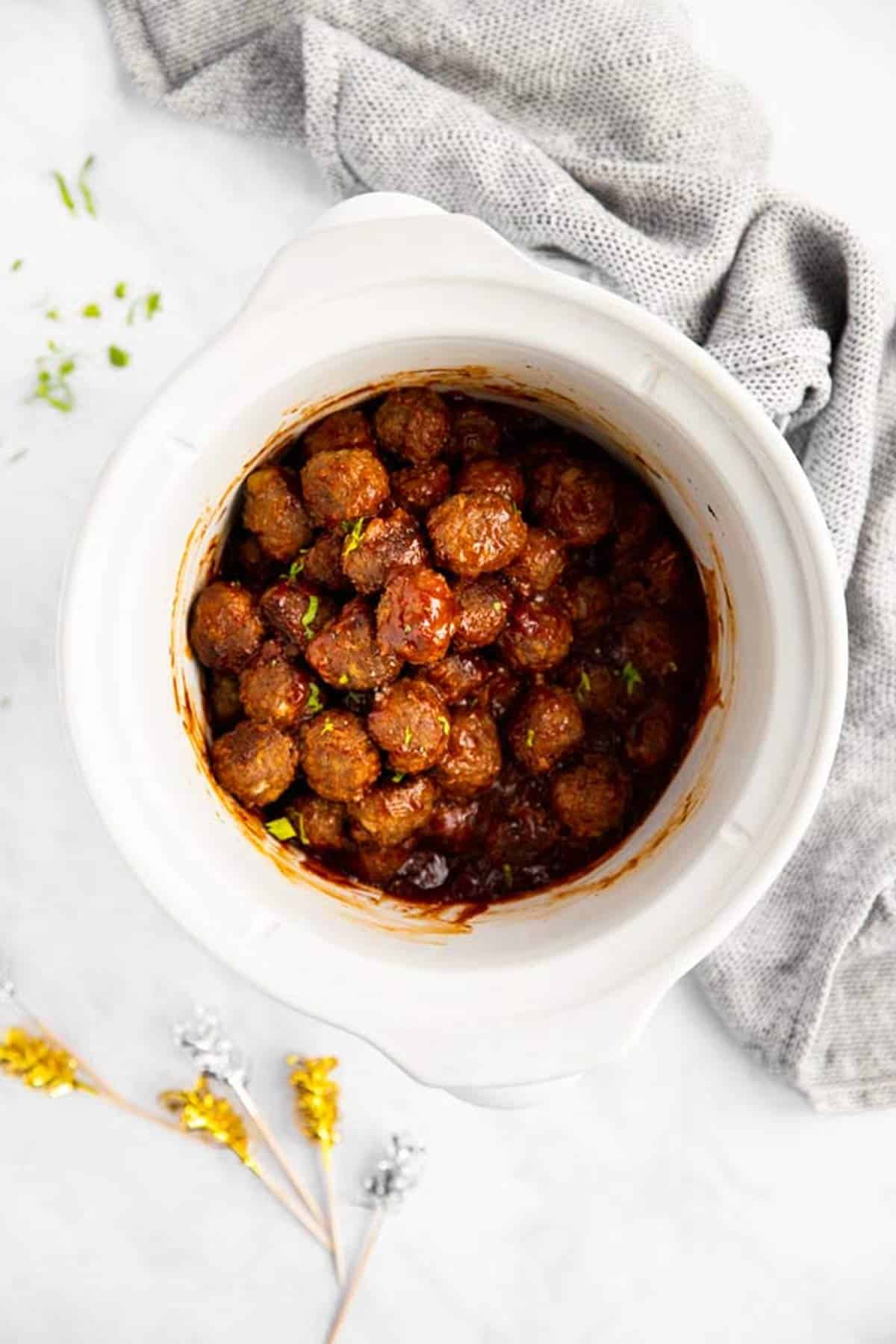 white slow cooker with bbq meatballs