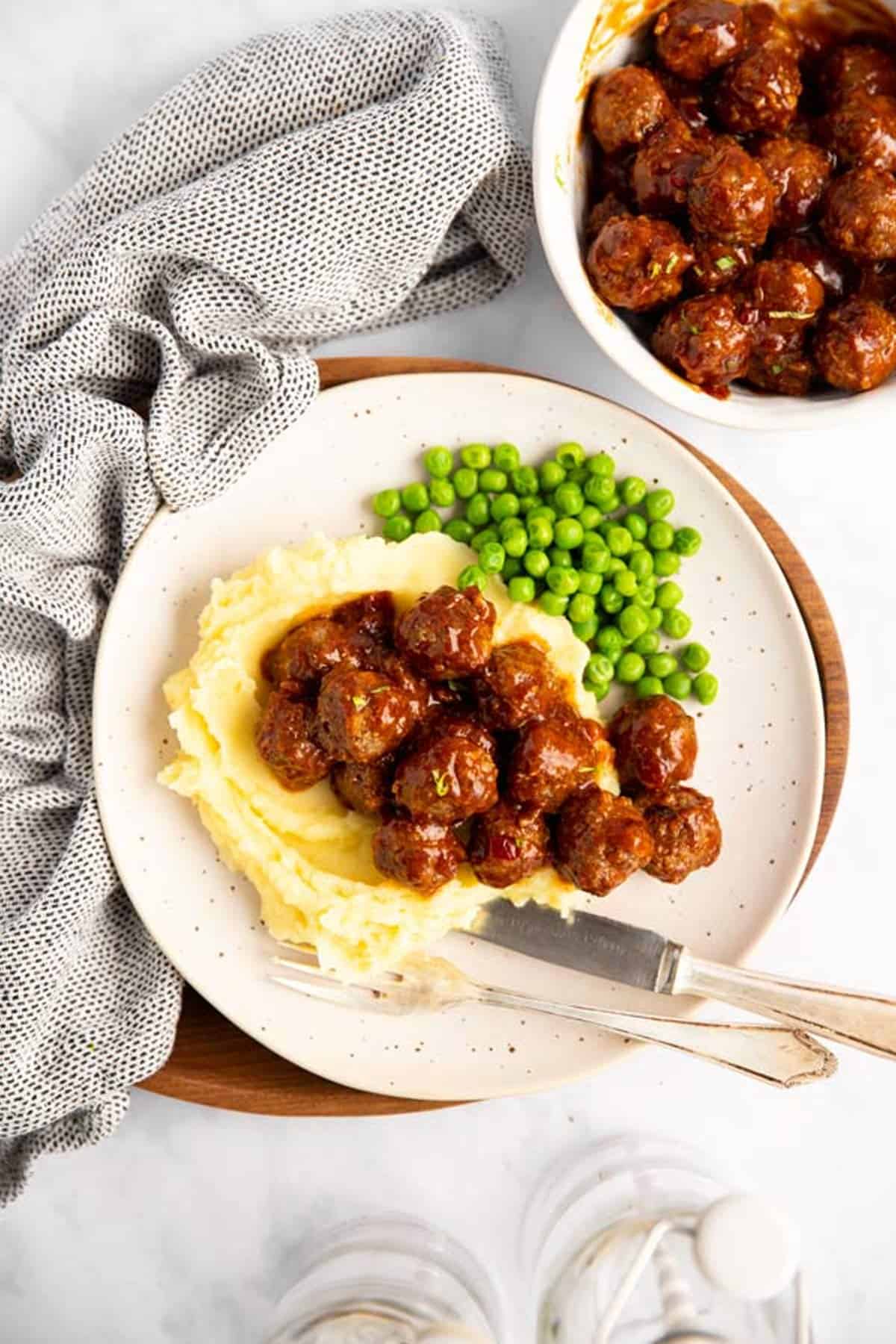 plate with mashed potatoes, peas and bbq meatballs