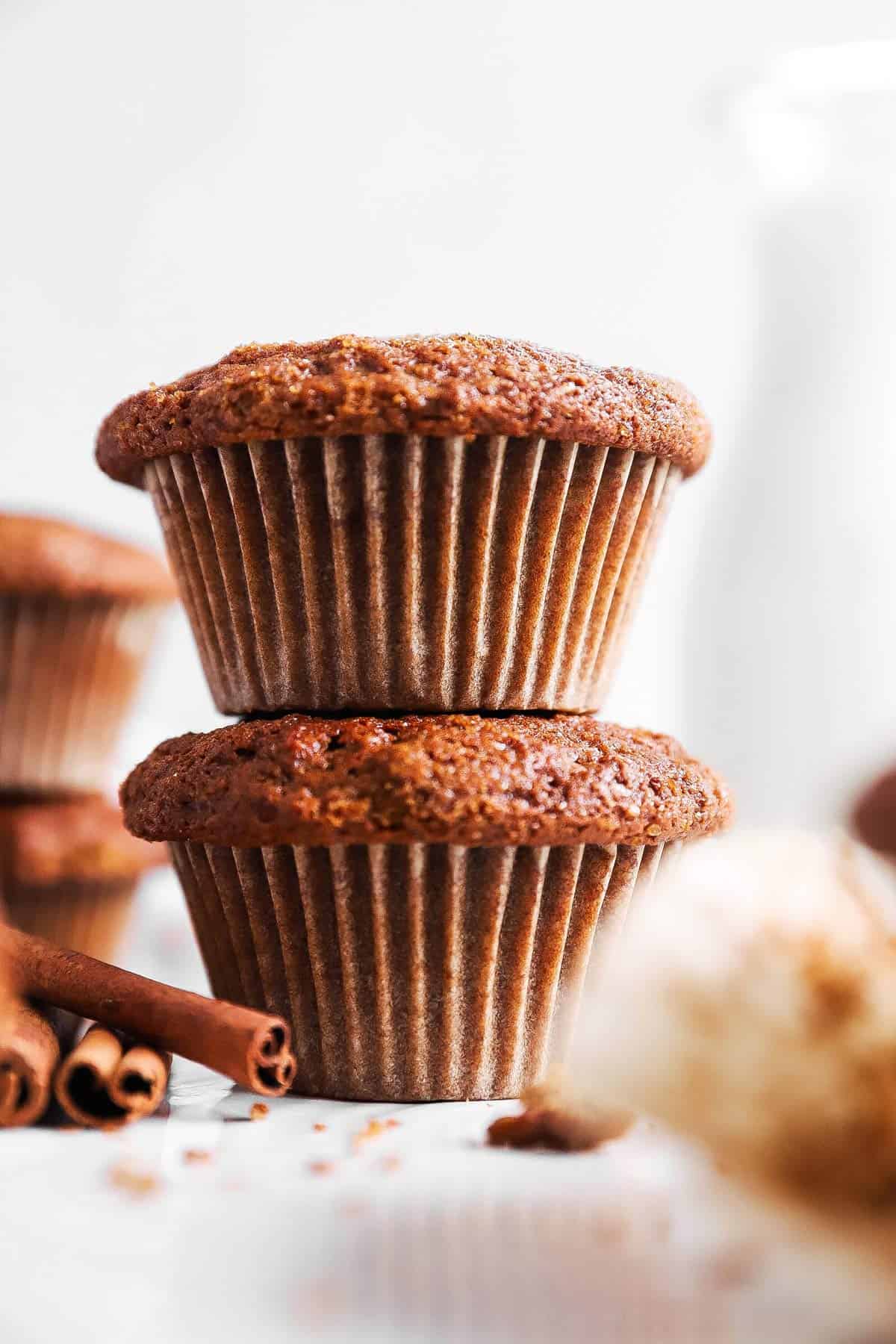 stack of gingerbread muffins in front of a milk bottle