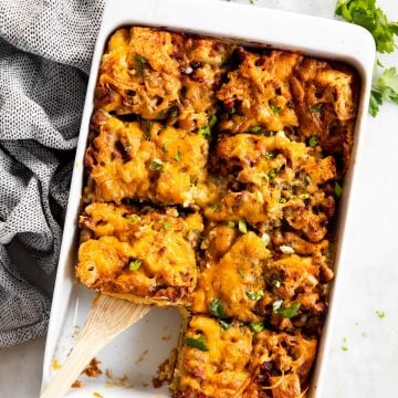 overhead view of overnight breakfast casserole with one slice removed