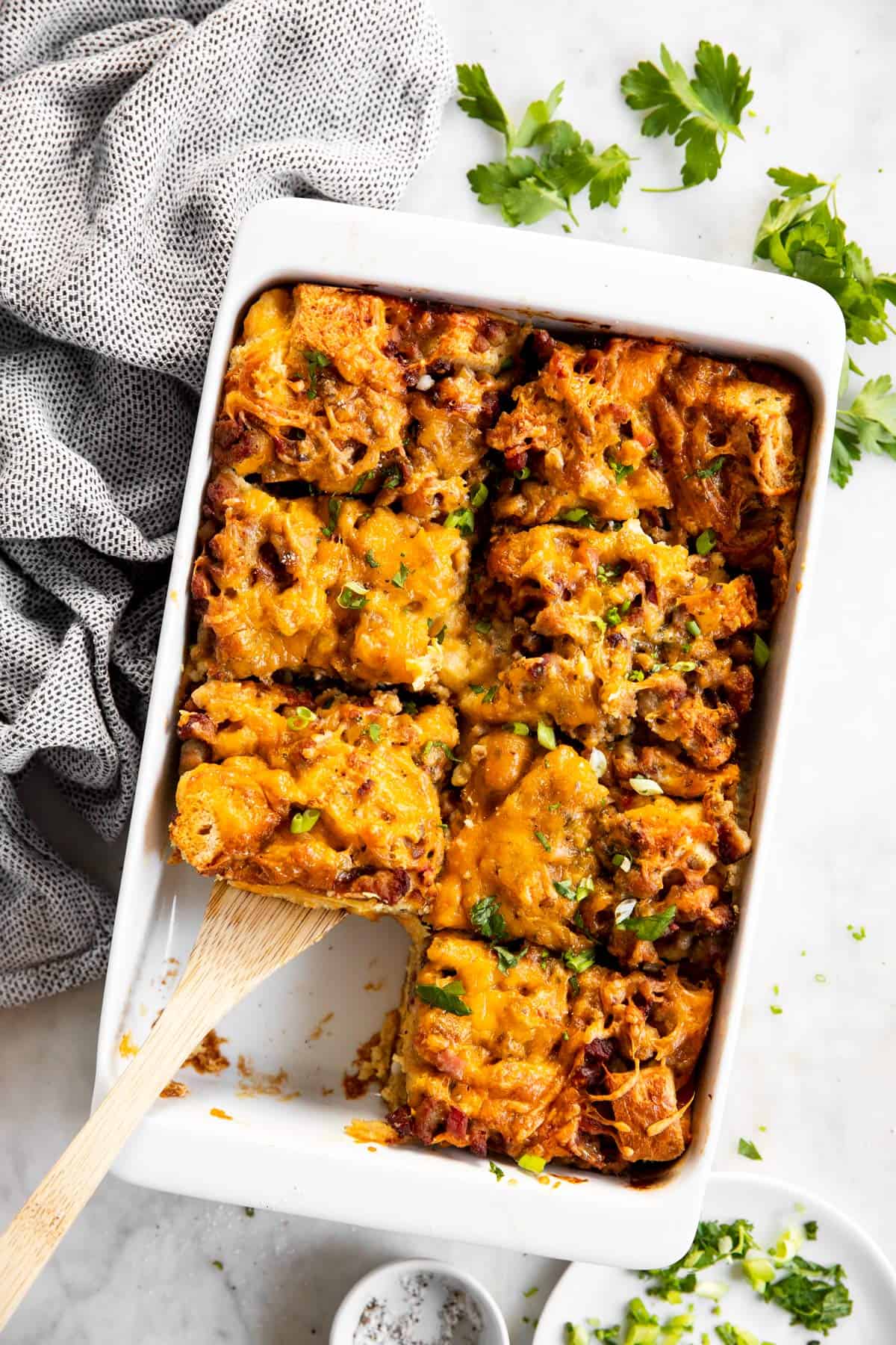 overhead view of overnight breakfast casserole with one slice removed