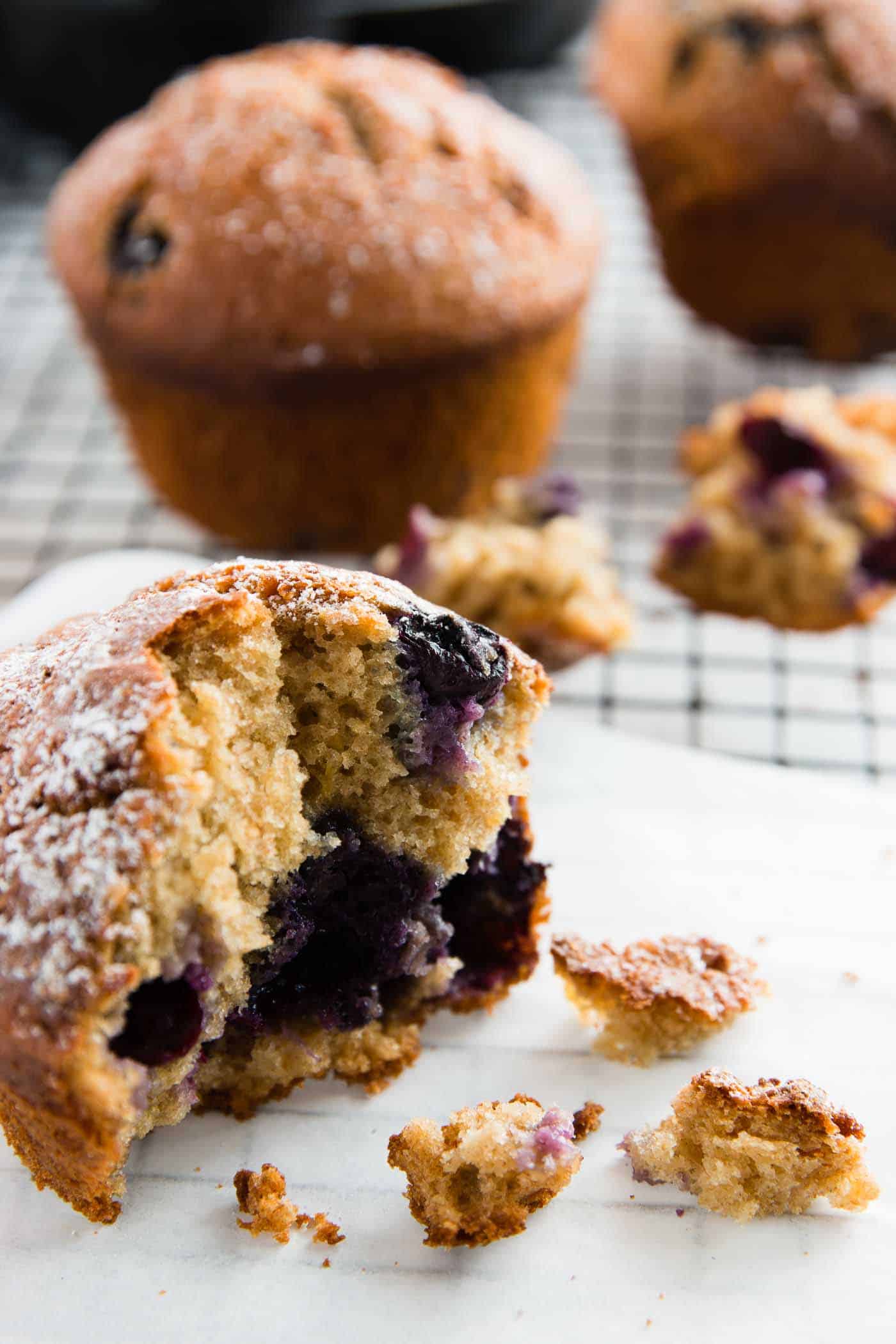 muffin sitting on a cooling rack, broken in half