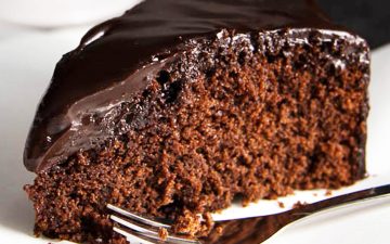 close up of chocolate honey cake on white plate
